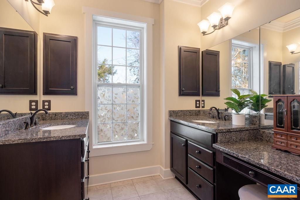 2052 Avinity Loop Charlottesville, VA 22902 - Photo 14 of 39 a bathroom with a granite countertop sink and a mirror