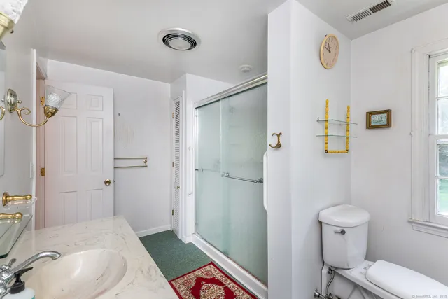 a bathroom with a sink toilet and shower