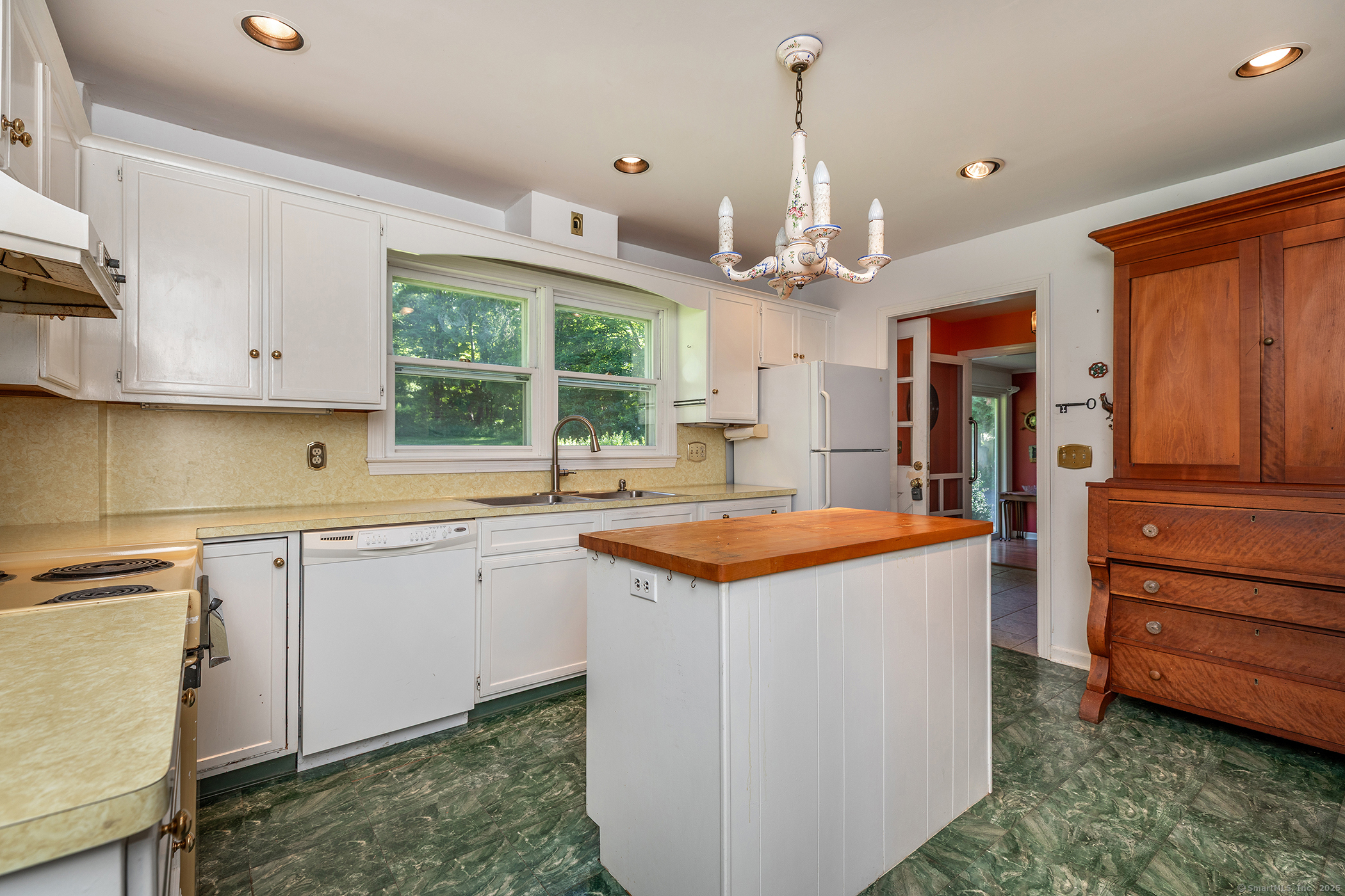 242 Tophet Road Roxbury, CT 06783 - Photo 6 of 25 a kitchen that has a kitchen island wooden cabinets and a window