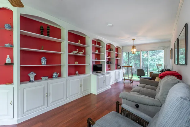 a living room with furniture closet and window