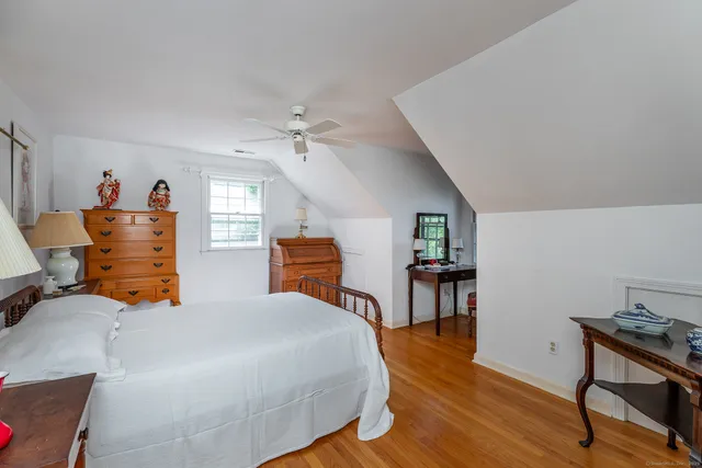 a bedroom with furniture and a wooden floor