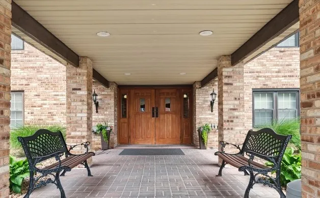 a balcony with furniture and wooden floor