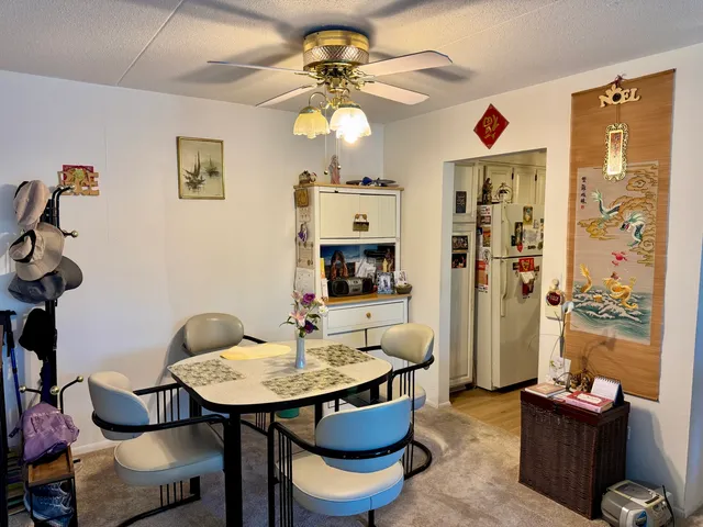 a view of a dining room with furniture and a chandelier