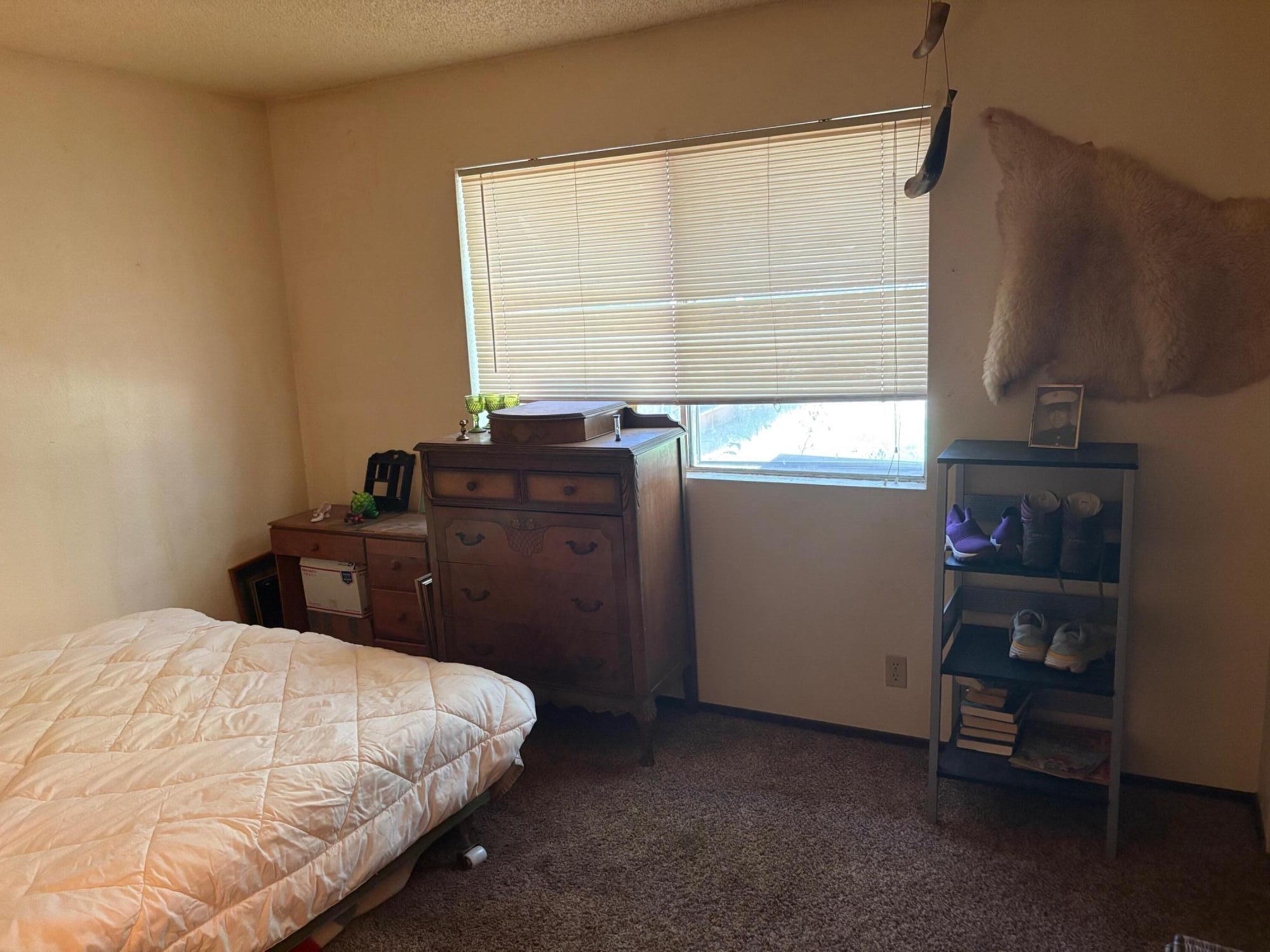 20194 Sugar Pine Street Burney, CA 96013 - Photo 12 of 15 a bedroom with a bed and a window
