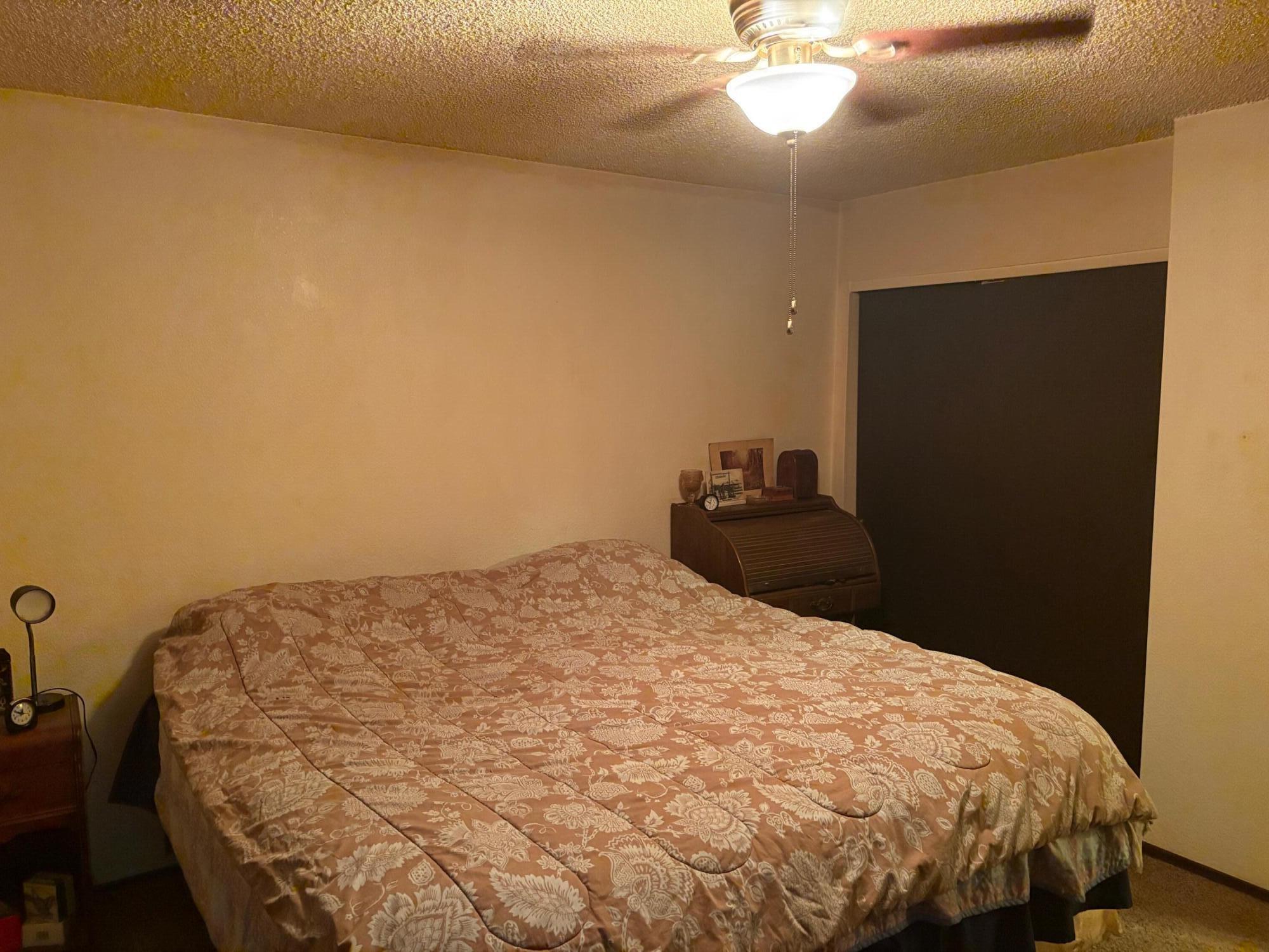 20194 Sugar Pine Street Burney, CA 96013 - Photo 13 of 15 a bedroom with a bed and a chandelier