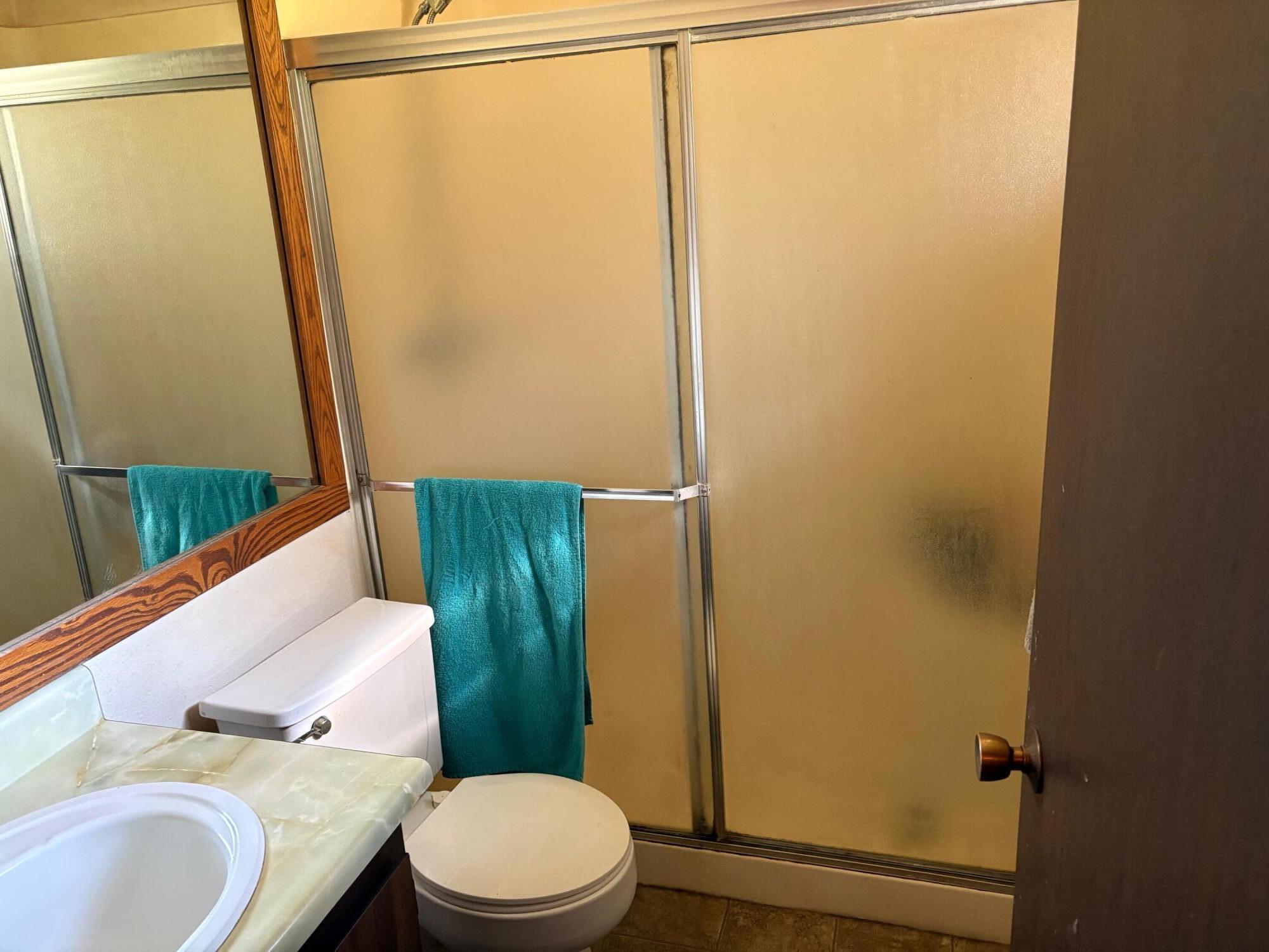 20194 Sugar Pine Street Burney, CA 96013 - Photo 15 of 15 a bathroom with a granite countertop sink toilet and shower