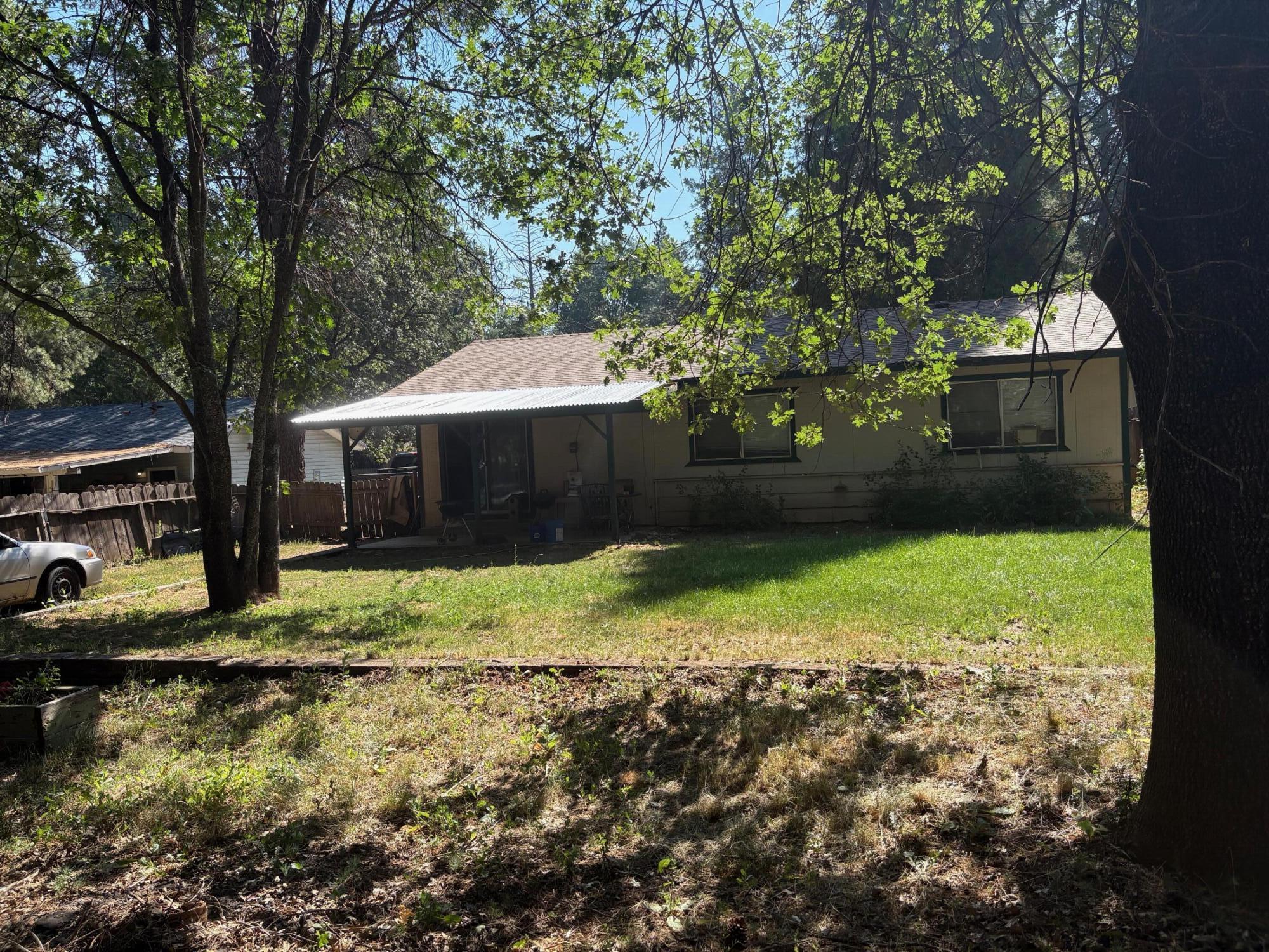 20194 Sugar Pine Street Burney, CA 96013 - Photo 4 of 15 a backyard of a house with a yard and outdoor seating