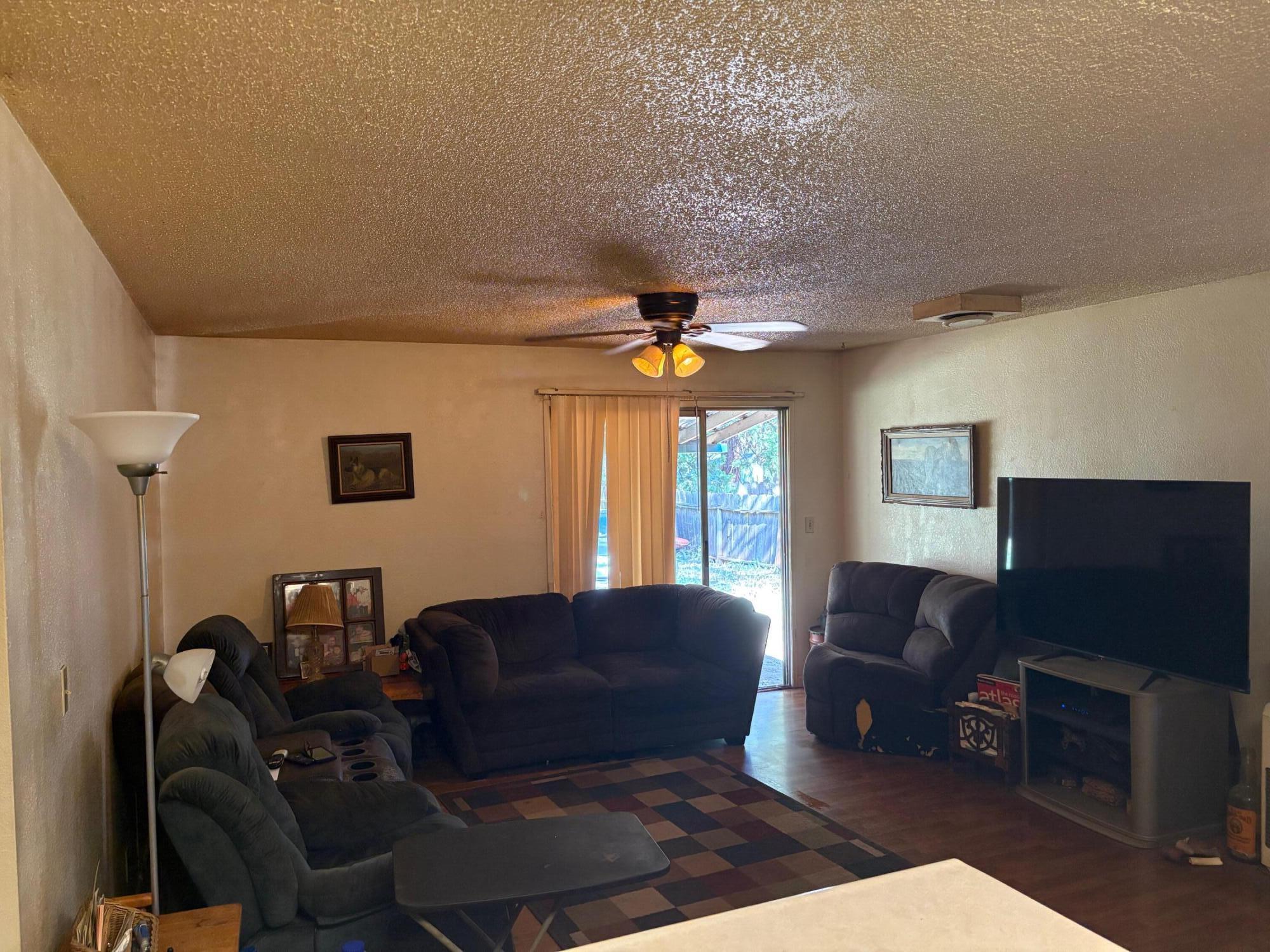 20194 Sugar Pine Street Burney, CA 96013 - Photo 6 of 15 a living room with furniture a ceiling fan and a window