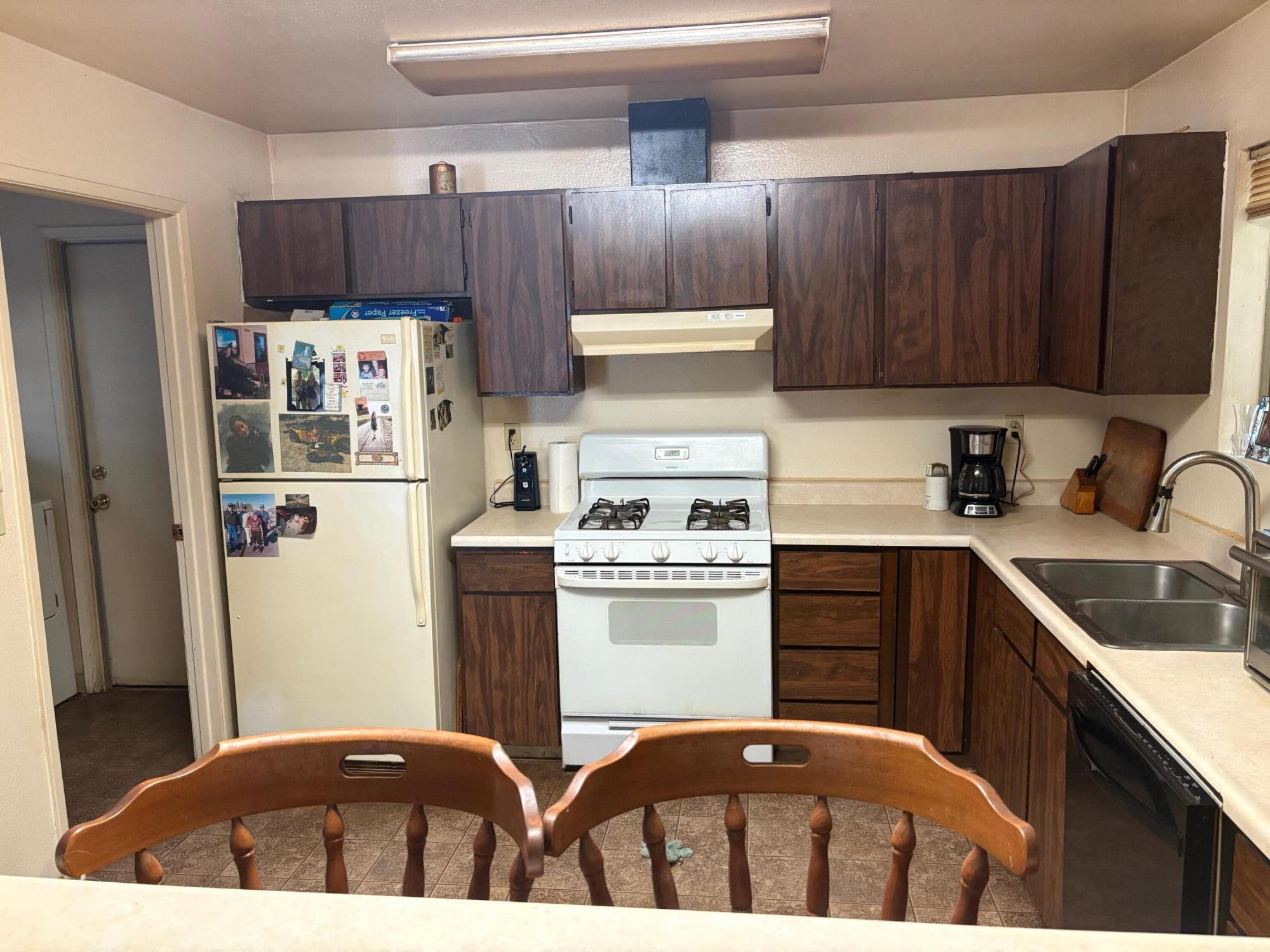 20194 Sugar Pine Street Burney, CA 96013 - Photo 9 of 15 a kitchen with stainless steel appliances a refrigerator sink and cabinets