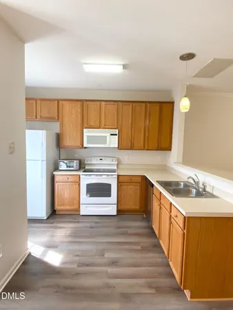 a kitchen with appliances a sink and a counter space