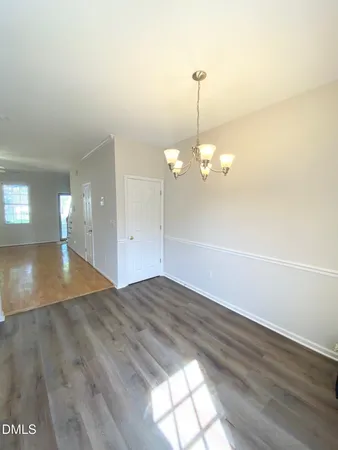 a view of a room with wooden floor and fan