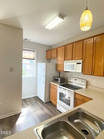 a kitchen with a stove a sink and a refrigerator