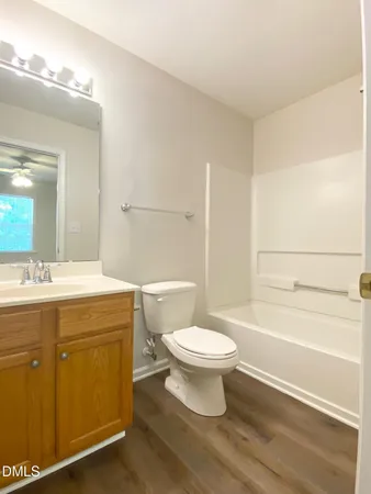 a bathroom with a sink toilet a mirror and shower