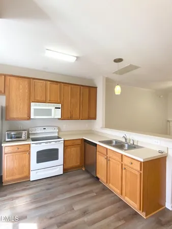 a kitchen with a stove top oven sink and cabinets