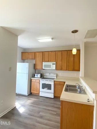 a kitchen with a stove sink and a refrigerator