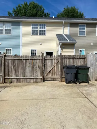 a view of a house with wooden fence