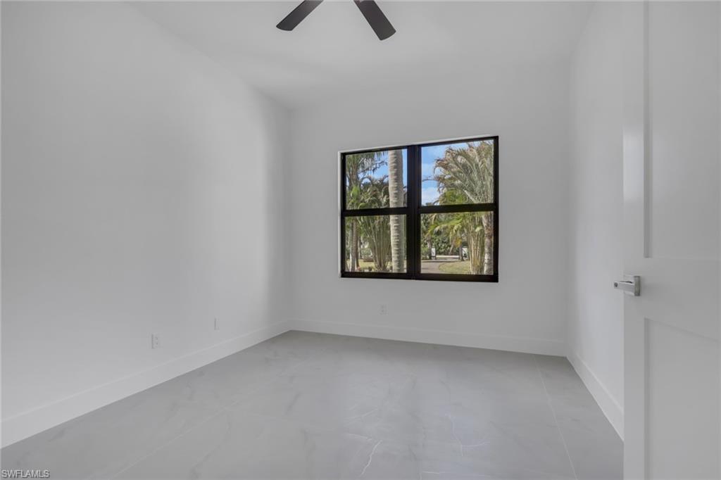 730 29th Street Southwest Naples, FL 34117 - Photo 23 of 50 Bathroom featuring tile walls, vanity, a shower stall, and recessed lighting