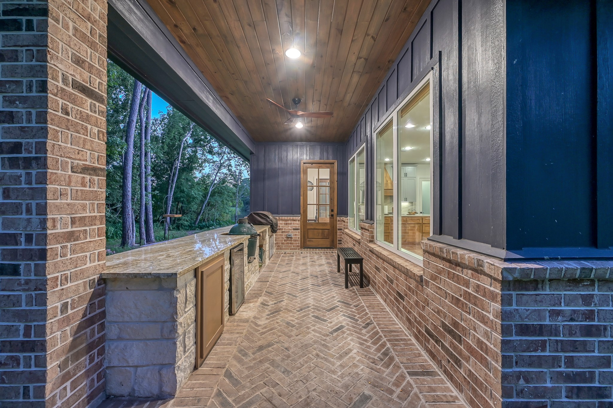 15937 Stagecoach Road Stagecoach, TX 77355 - Photo 17 of 50 Experience the ultimate outdoor oasis with this side patio, featuring a high-end kitchen equipped with an Egg Smoker, gas grill, and beverage cooler. Conveniently located just outside the indoor kitchen.