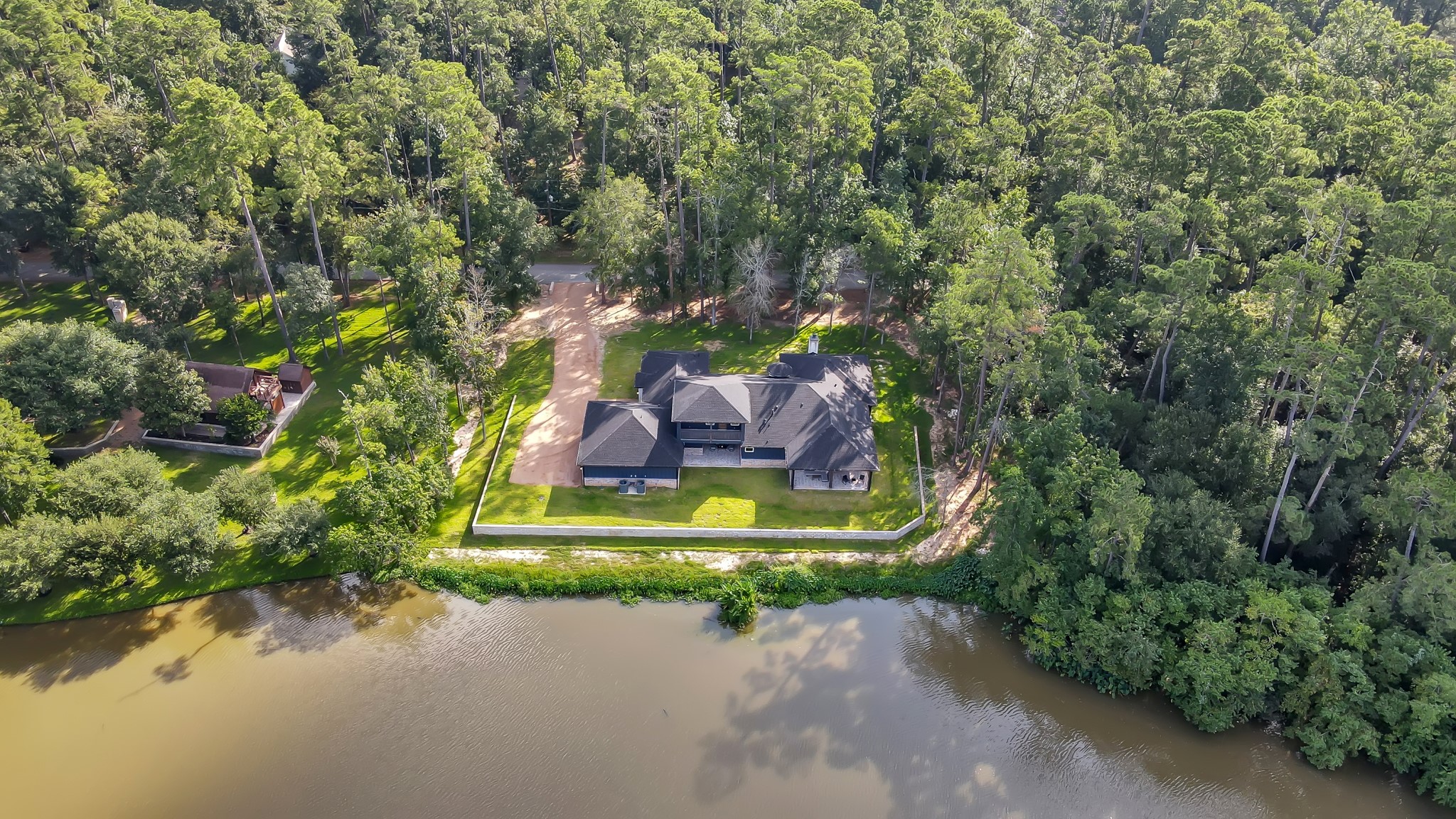15937 Stagecoach Road Stagecoach, TX 77355 - Photo 49 of 50 a view of a garden with a fountain and large trees