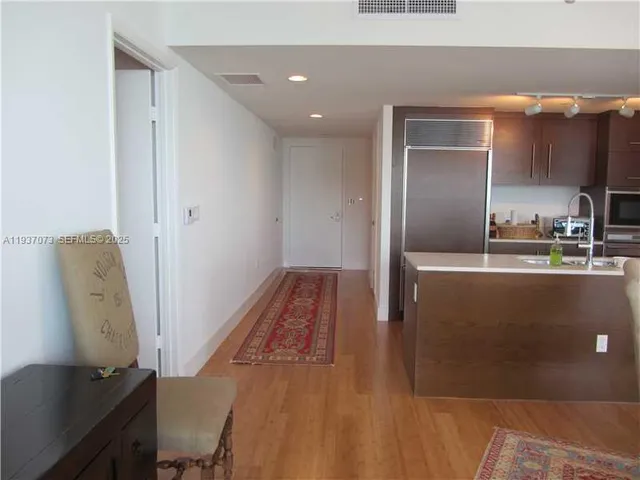 a living room with flat screen tv and a floor to ceiling window