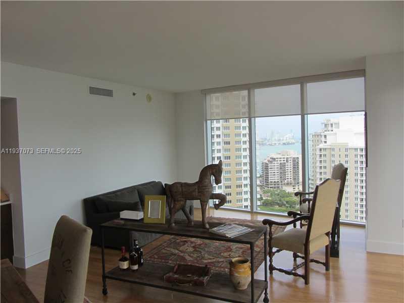 495 Brickell Avenue, Unit 2401 Miami, FL 33131 - Photo 14 of 33 a living room with furniture and a window