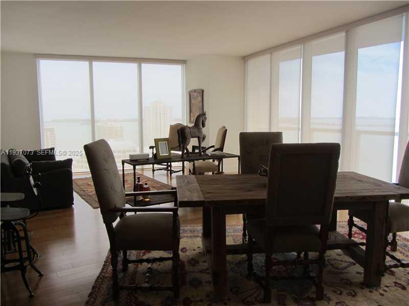 495 Brickell Avenue, Unit 2401 Miami, FL 33131 - Photo 16 of 33 a dining room with furniture and window
