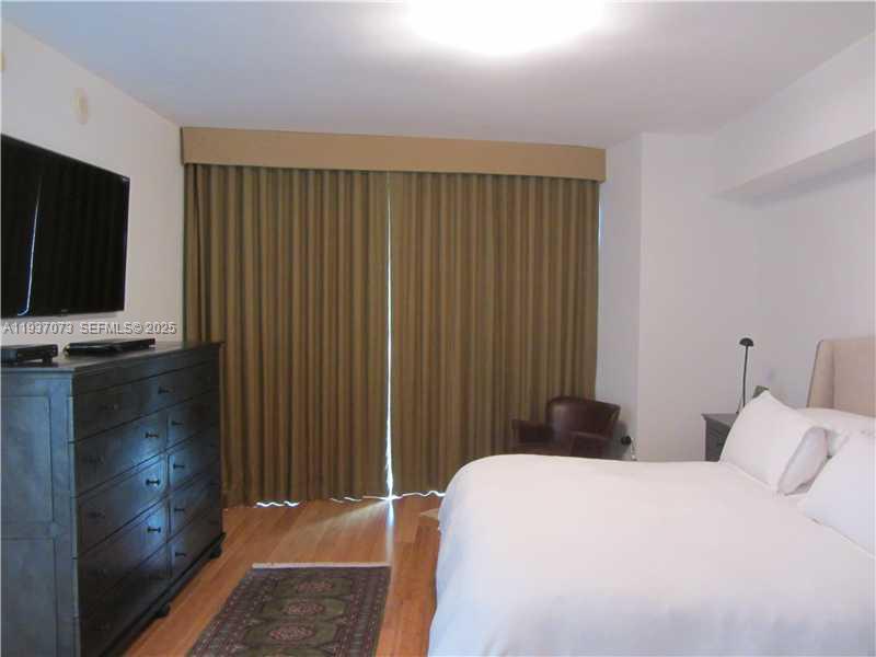 495 Brickell Avenue, Unit 2401 Miami, FL 33131 - Photo 20 of 33 a bedroom with a bed and a flat screen tv
