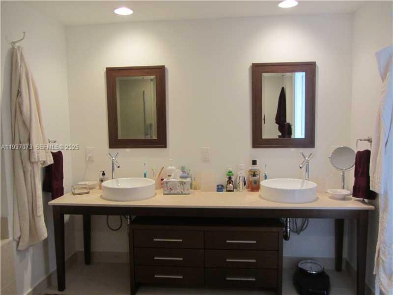 495 Brickell Avenue, Unit 2401 Miami, FL 33131 - Photo 24 of 33 a bathroom with a sink and a mirror