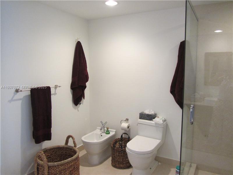 495 Brickell Avenue, Unit 2401 Miami, FL 33131 - Photo 26 of 33 a bathroom with a toilet sink and mirror