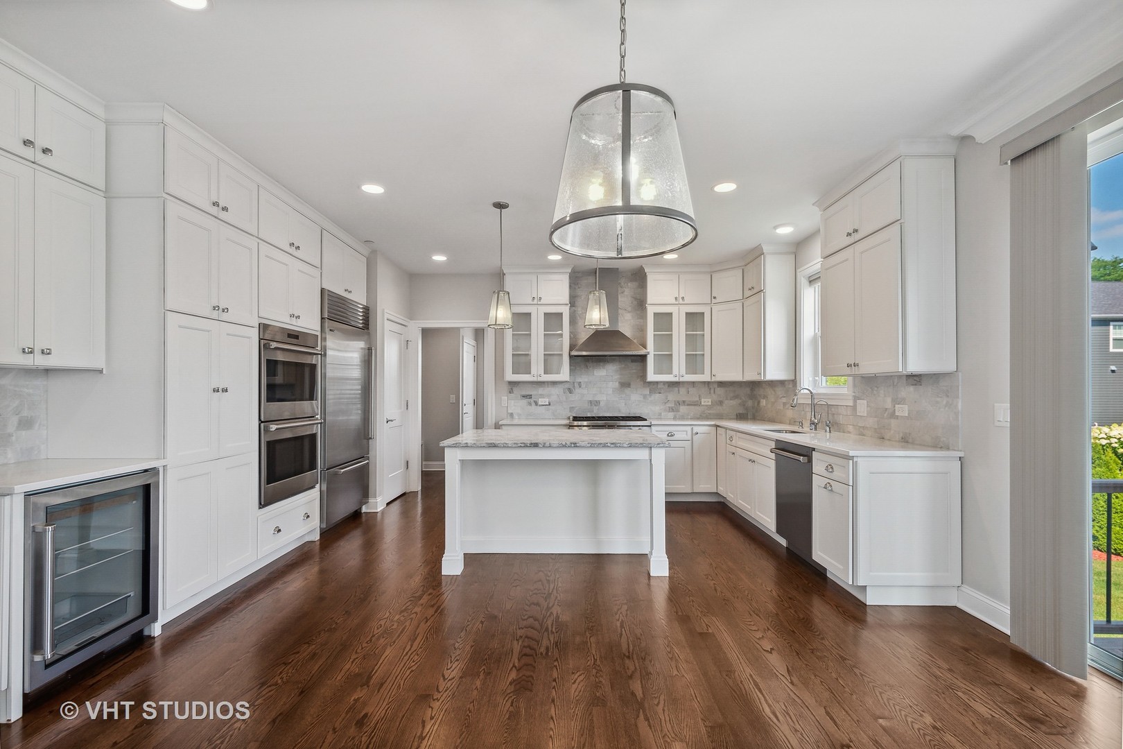 2004 West Sibley Street Park Ridge, IL 60068 - Photo 5 of 40 a kitchen with stainless steel appliances a stove a sink dishwasher a refrigerator and white cabinets with wooden floor