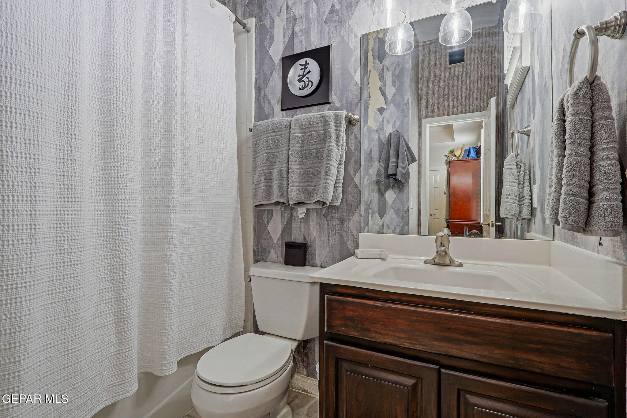 5806 Diamond Point Circle El Paso, TX 79912 - Photo 40 of 61 a bathroom with a granite countertop toilet sink and mirror