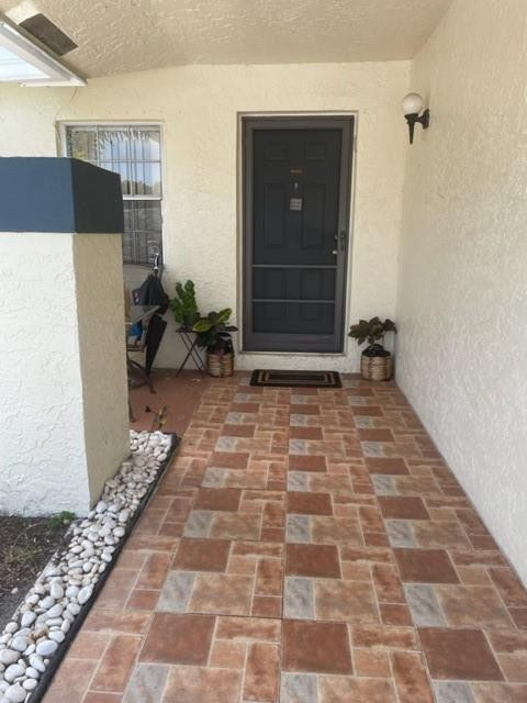 9869 Three Lakes Circle, Unit 6B Boca Raton, FL 33428 - Photo 3 of 8 PAVER ENTRANCE