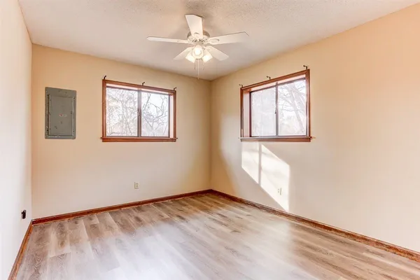 wooden floor in an empty room with a window