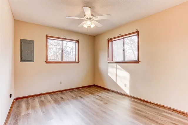 wooden floor in an empty room with a window