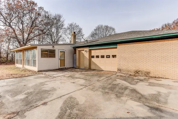 a view of a house with a snow on the road
