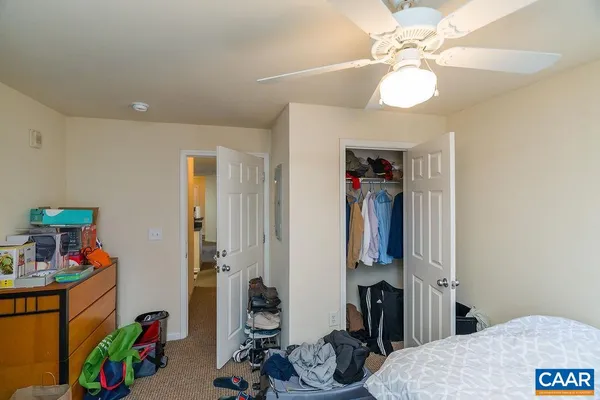 a living room with furniture and a view of kitchen