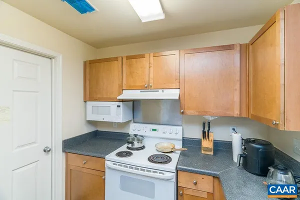 a kitchen with a stove a sink and cabinets