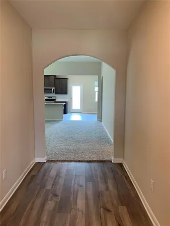 a view of a kitchen from the hallway