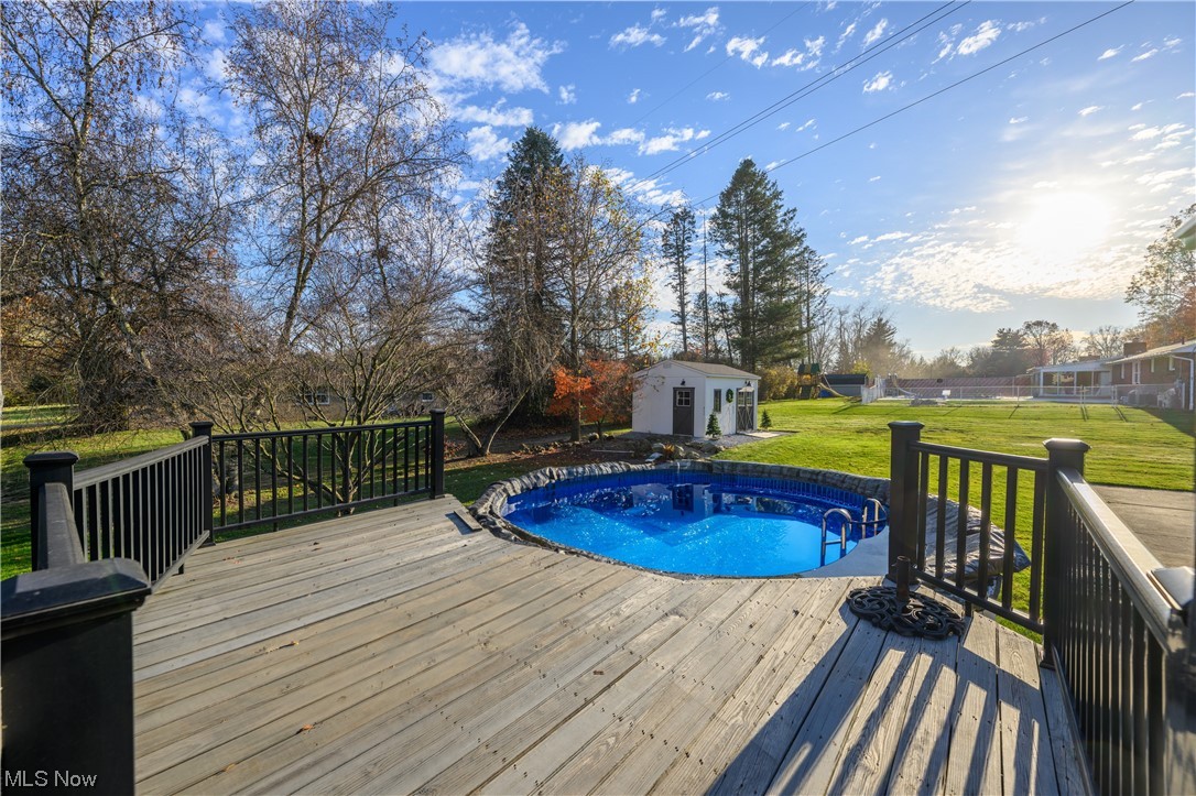 5304 Sibila Road Northwest Canton, OH 44718 - Photo 7 of 29 View of swimming pool featuring a yard, a wooden deck, and an outdoor structure