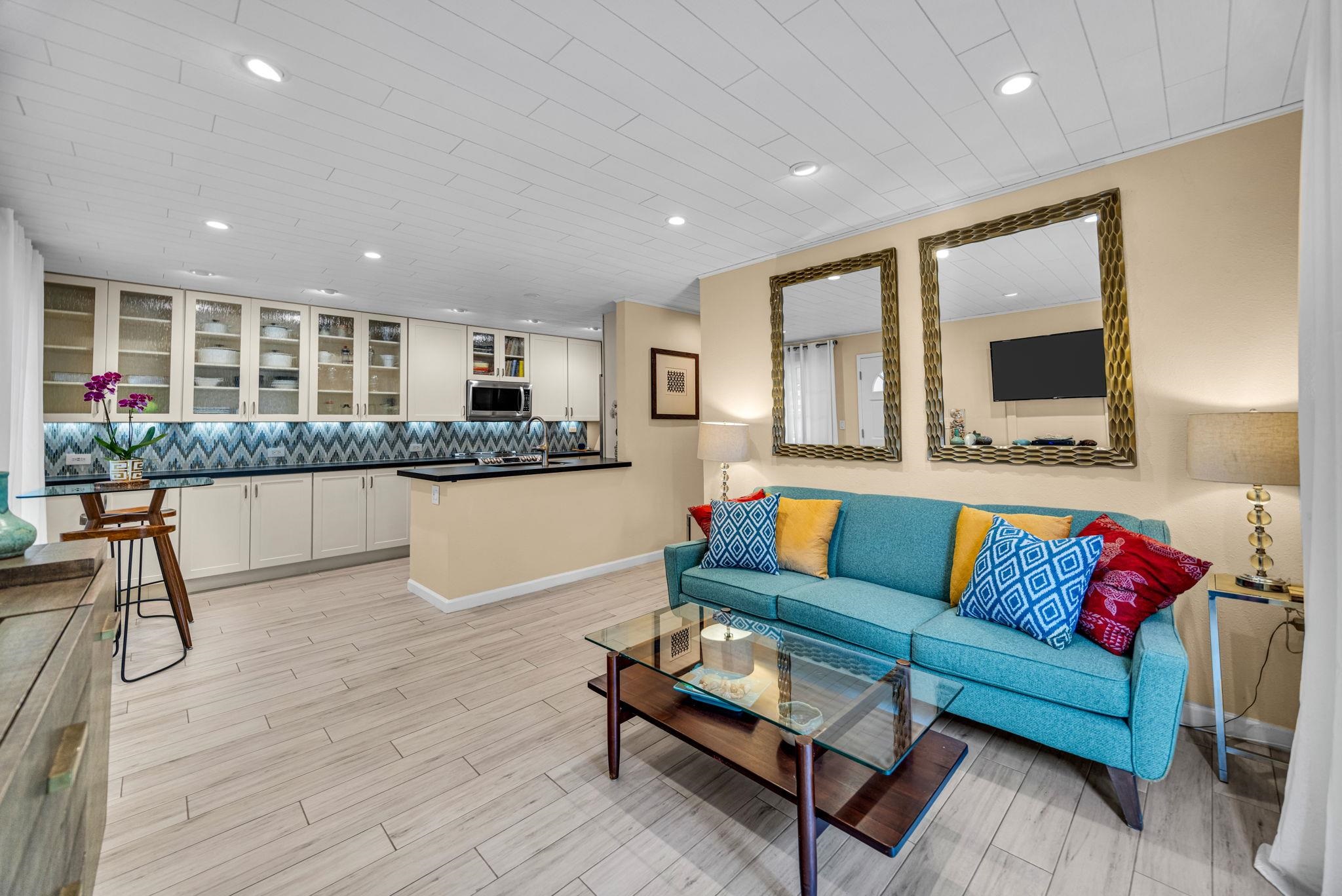 a living room with furniture and a wooden floor