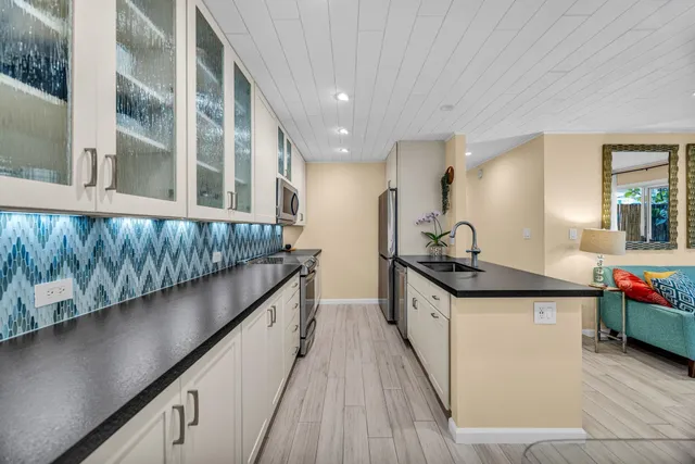 a kitchen with stainless steel appliances granite countertop counter space a sink and cabinets