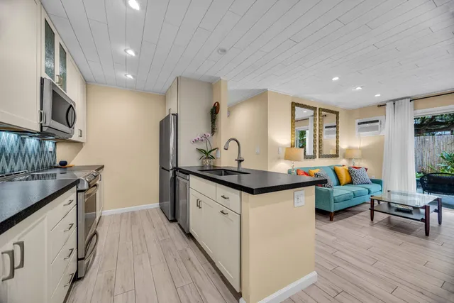 a kitchen with granite countertop lots of counter top space and stainless steel appliances