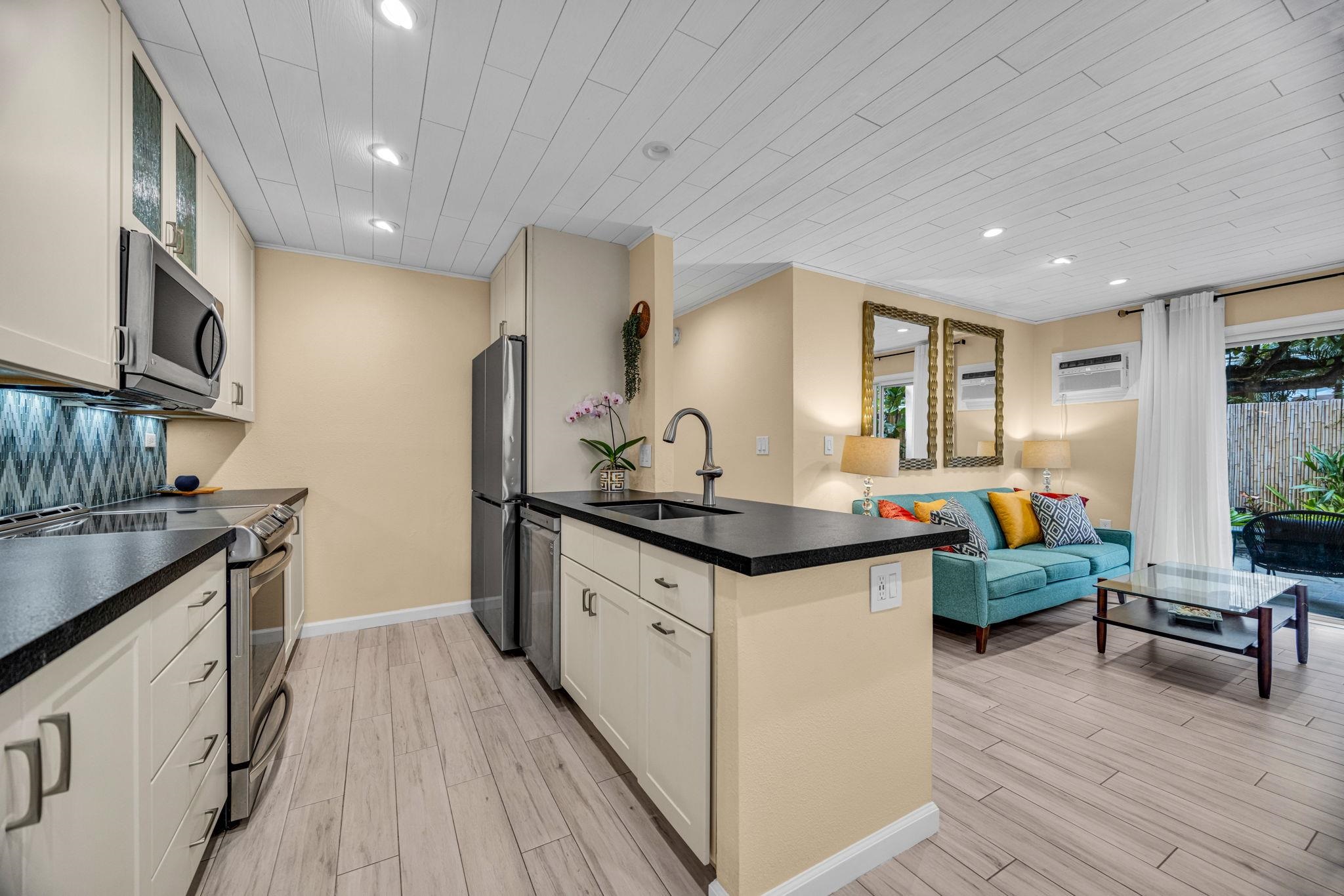 160 Keonekai Road, Unit 8103 Kihei, HI 96753 - Photo 15 of 47 a kitchen with granite countertop lots of counter top space and stainless steel appliances