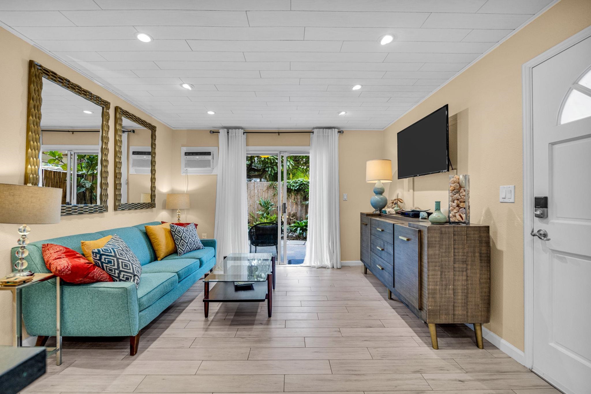 160 Keonekai Road, Unit 8103 Kihei, HI 96753 - Photo 16 of 47 a living room with furniture and a flat screen tv