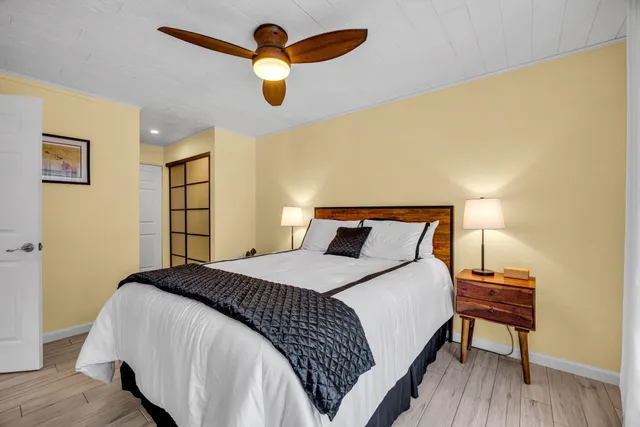 a bedroom with a bed and a chandelier