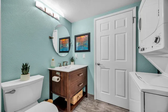 a bathroom with a toilet a sink and a mirror