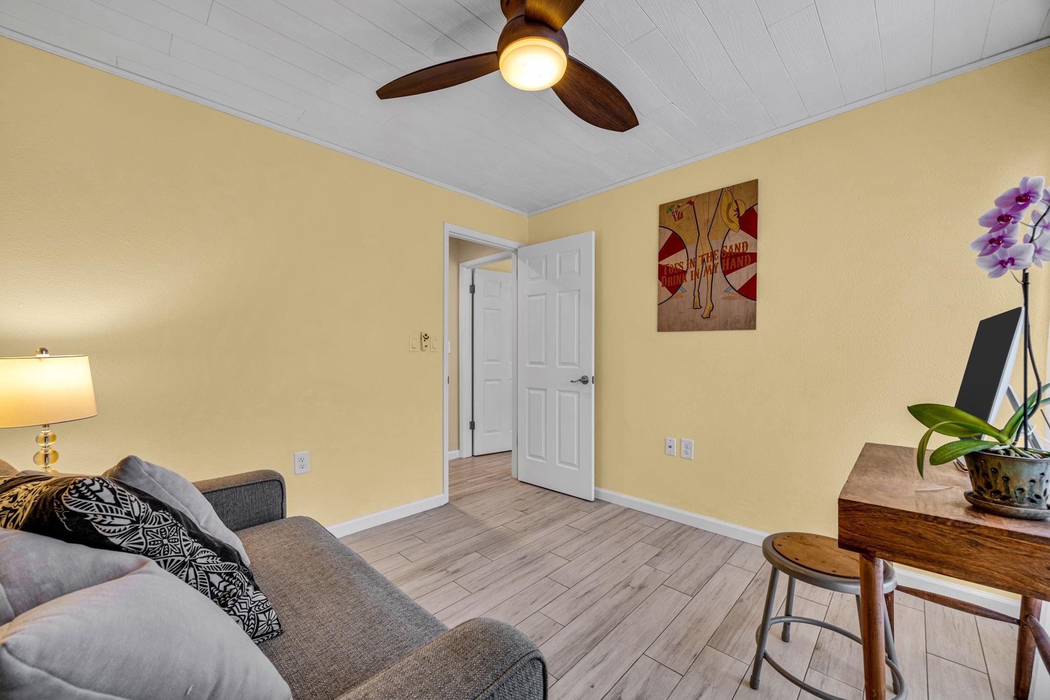 160 Keonekai Road, Unit 8103 Kihei, HI 96753 - Photo 26 of 47 a bedroom with a bed and a chandelier