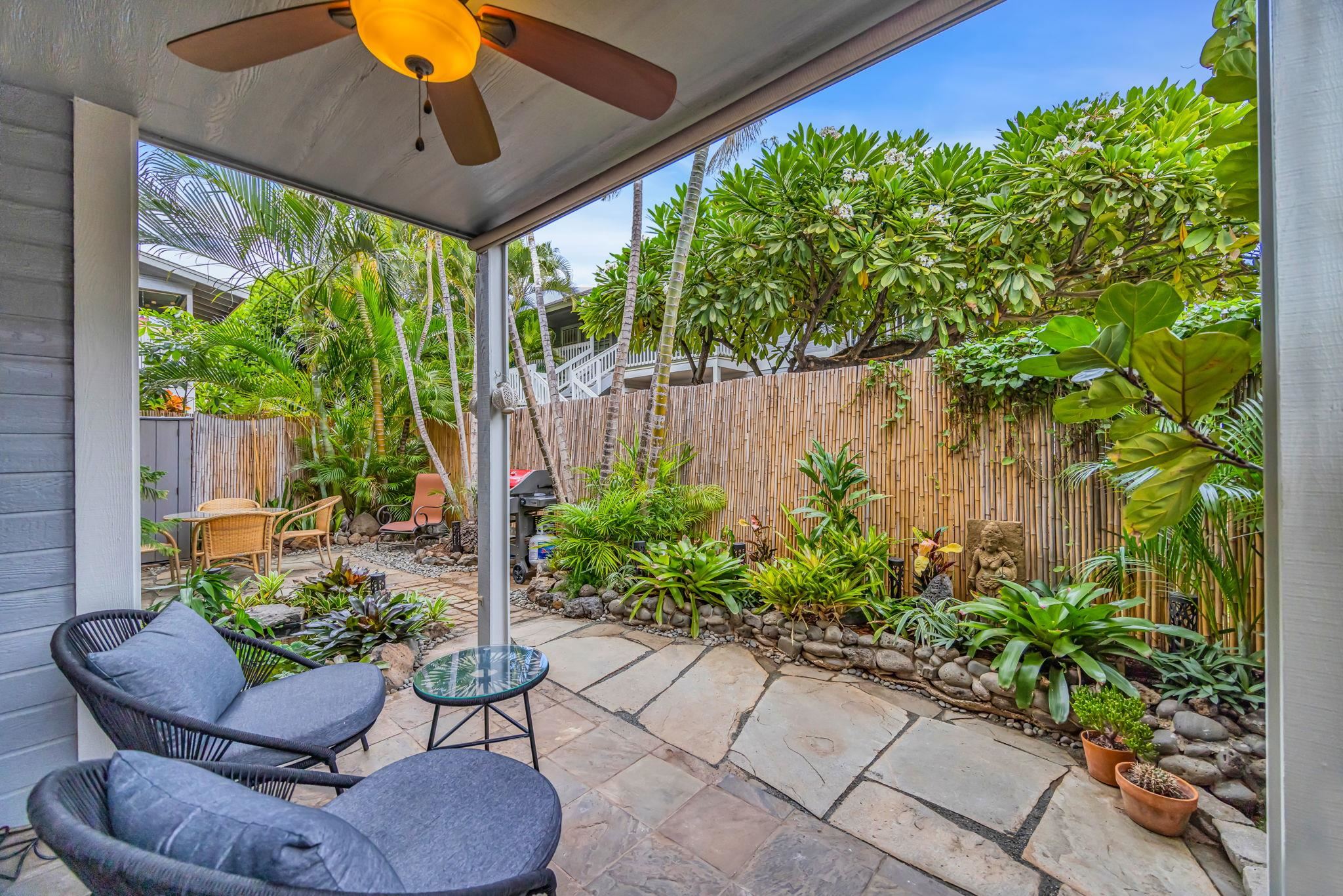 160 Keonekai Road, Unit 8103 Kihei, HI 96753 - Photo 32 of 47 a view of a chairs and table in a backyard
