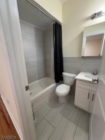 a white toilet sitting next to a bathroom sink and vanity