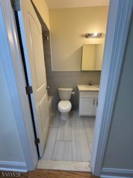 38 Blum Street Newark, NJ 07103 - Photo 15 of 15 a bathroom with a sink a toilet a mirror and vanity